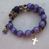 Light purple Czech glass with gold pewter rondelles, gold plated cross, and amythest spacers.